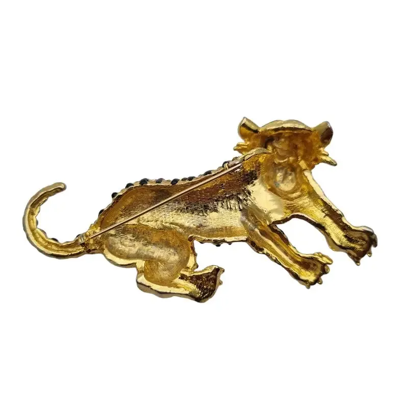 Golden panther brooch with green rhinestones and black enamel, vintage jewelry.